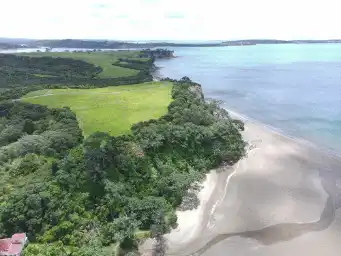 Large triangular beach with NZ bush and fields