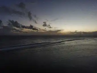 Sunset at big beach with sweeping waves